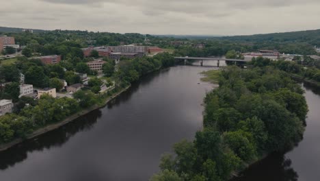 aerial view over magog river in sherbrooke, canada - drone shot