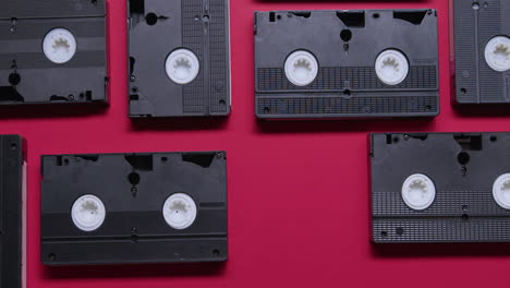 vhs cassettes on burgundy background