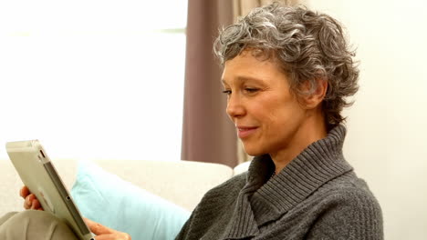 Woman-using-tablet-while-sitting