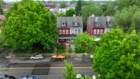 Reverse-drone-shot-of-house-in-city