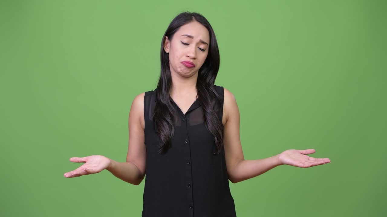 Young beautiful Asian businesswoman shrugging shoulders