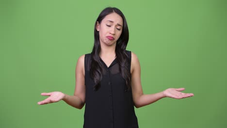 young beautiful asian businesswoman shrugging shoulders