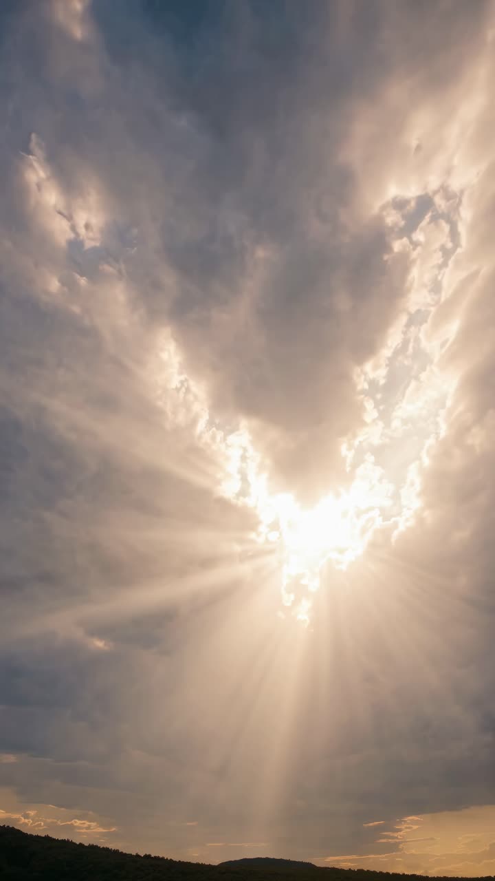 Dramatic video concept of sun rays breaking through clouds, captured from a low angle