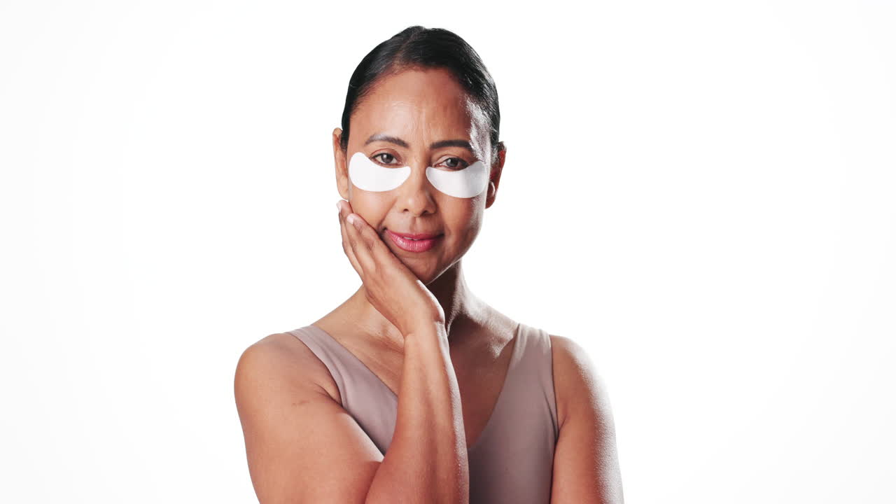 Mature Woman Applying Under Eye Patches for Skincare