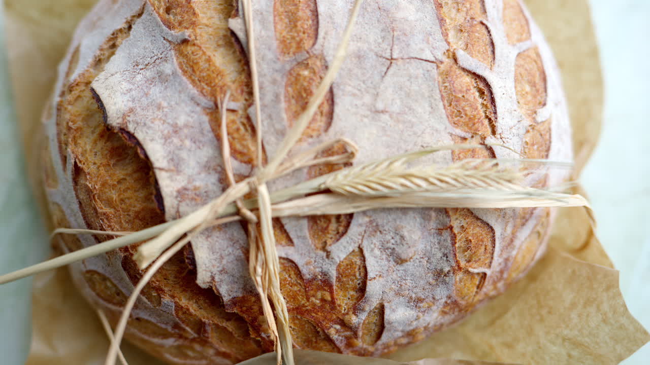 Close up of a whole wheat bread on a table in daylight