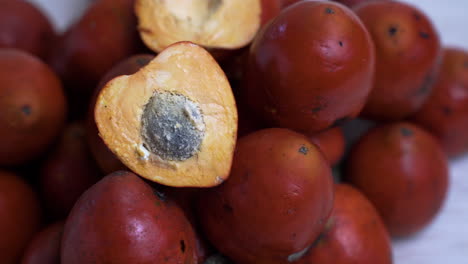 close up pan of chontaduro fruit with seed pip from amazon rainforest jungle in ecuador