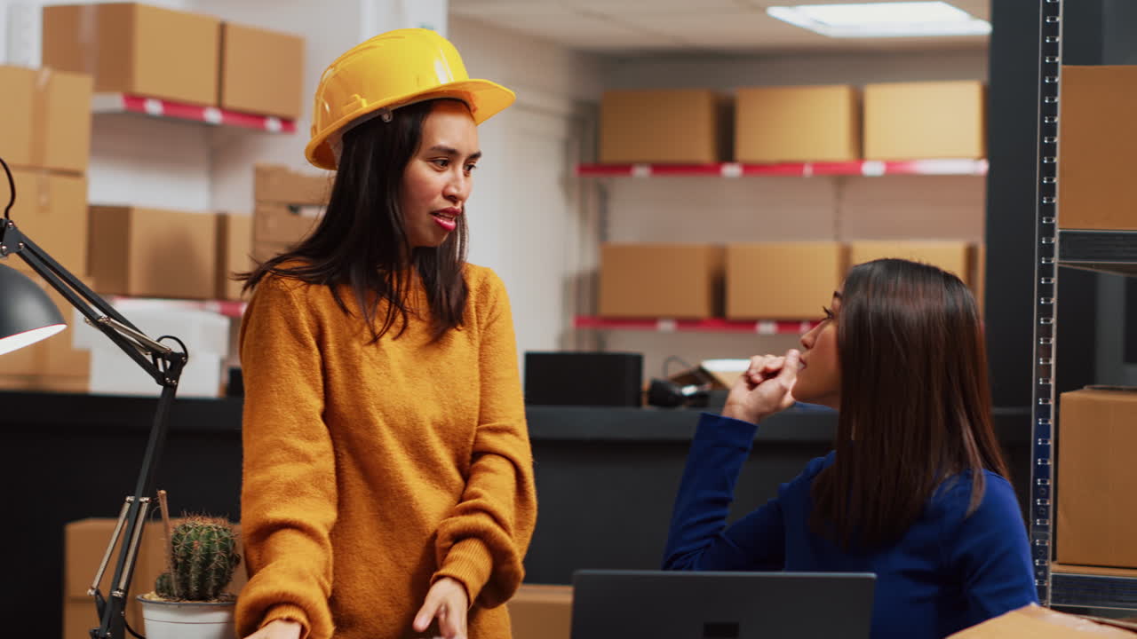 Women working with packages in warehouse