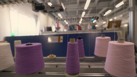 spools of color thread on knitting machine