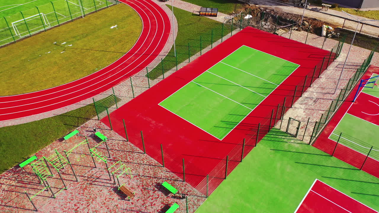Modern sports grounds. Flight over colorful stadiums with nobody. Modern fields for playing different sport outdoors.