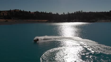 SLOWMO---Jet-Ski-on-Beautiful-Turquoise-Blue-Water---Lake-Tekapo,-New-Zealand---Aerial