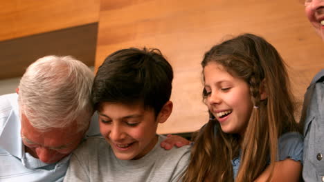 grandparents laughing with their grandchildren