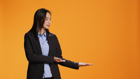 asian employee points at left or right sides in studio