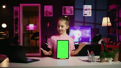 Cute-kid-filming-internet-show,-promoting-green-screen-tablet-received-from-sponsoring-brand