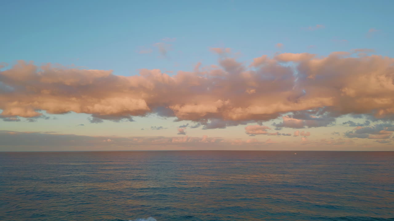 Aerial tranquil ocean sunset painting clouds pink. Peaceful horizon glowing