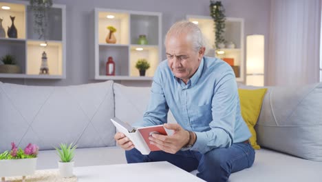 Old-man-looking-at-family-album-with-trembling-hand.