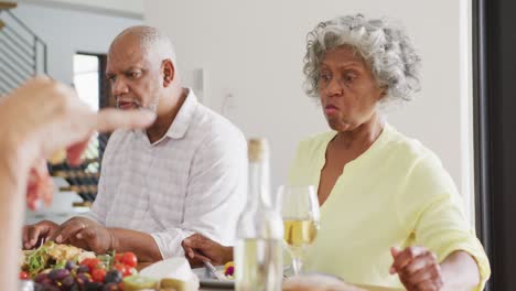 Happy-senior-diverse-people-having-dinner-at-retirement-home