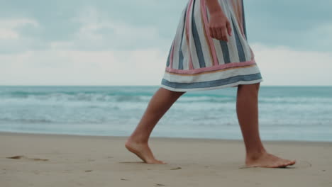 Unknown-girl-relaxing-at-seashore.-Unrecognizable-woman-walking-along-at-beach.