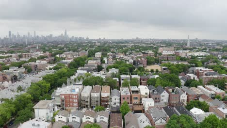 drone flying away from rows of urban houses in chicago