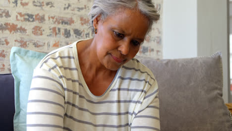 Front-view-of-old-asian-senior-woman-using-laptop-in-living-room-at-home-4k