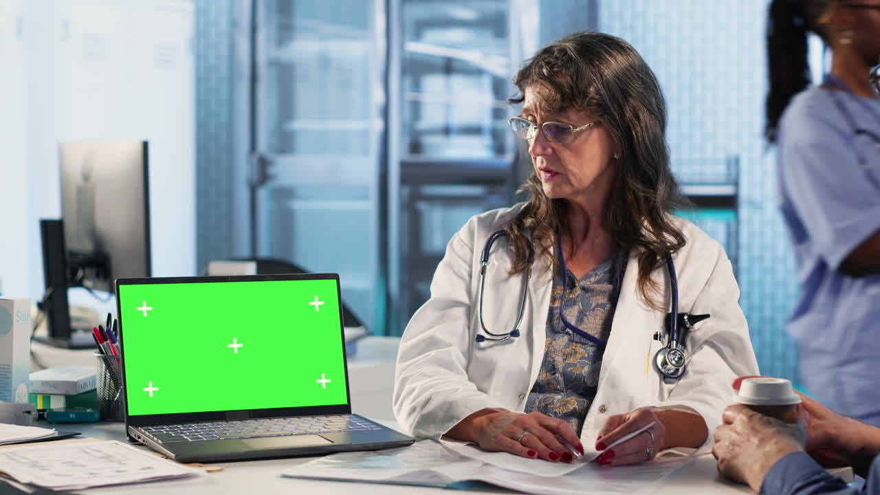 Old medical staff consulting a male patient next to chroma key space