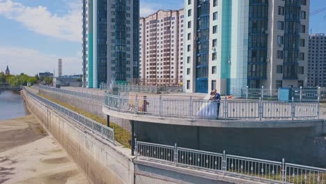 happy bride with groom on viewpoint in city upper view