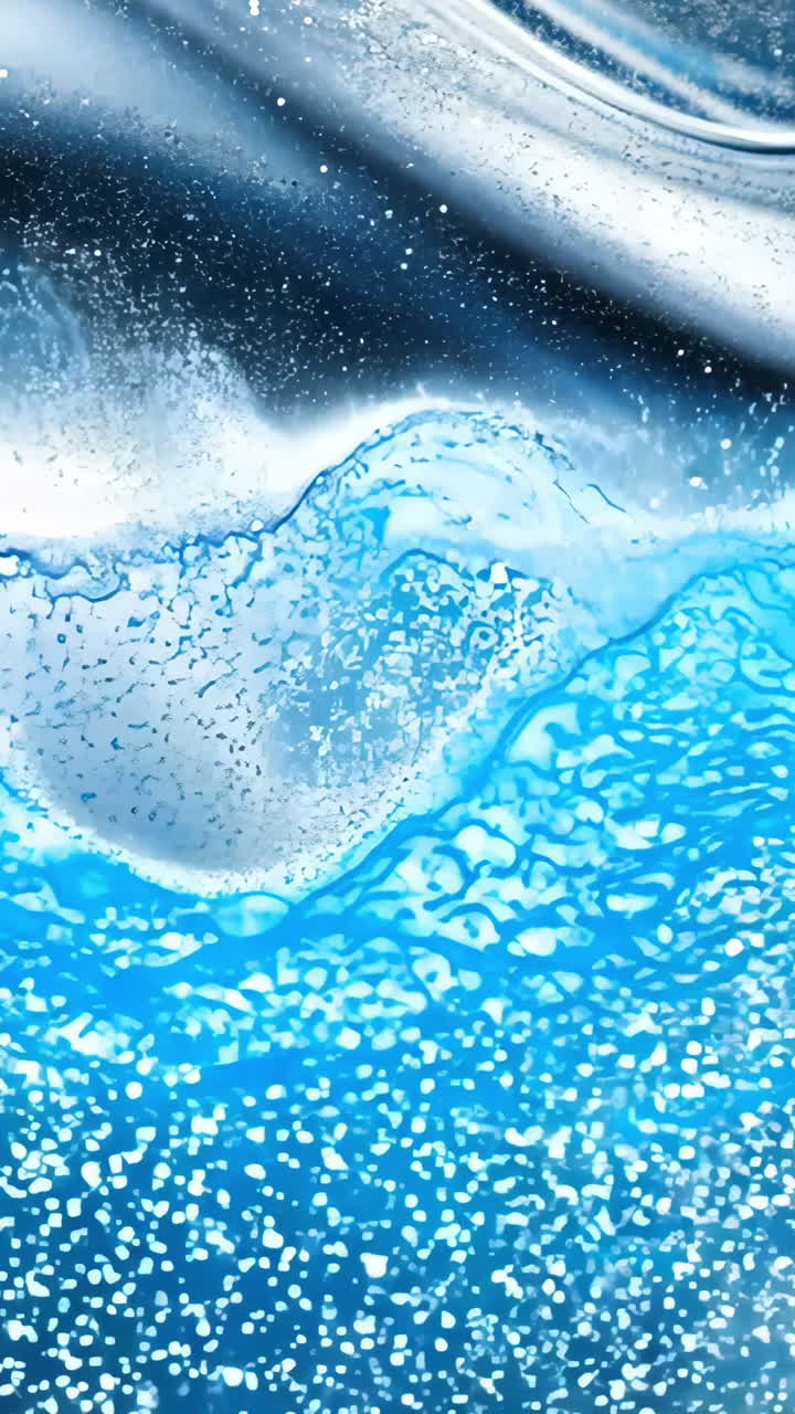 A blue and silver fabric with a wavy pattern. The fabric is covered in glitter. The image has a shiny and reflective quality to it