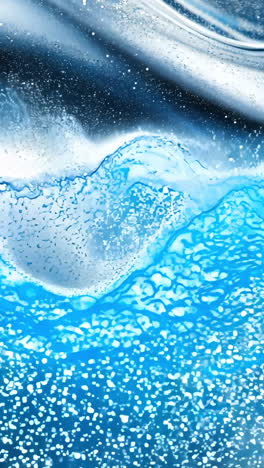 a blue and silver fabric with a wavy pattern. the fabric is covered in glitter. the image has a shiny and reflective quality to it