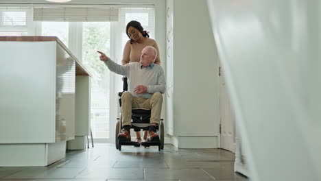 elderly man in wheelchair assisted by caregiver