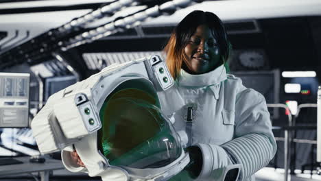 portrait of happy astronaut holding helmet in space station completing mission