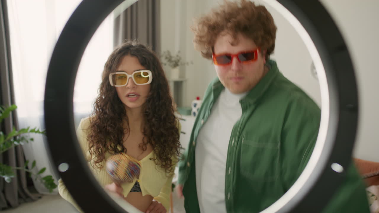 Young Couple in Sunglasses Dancing during Social Media Video Shoot