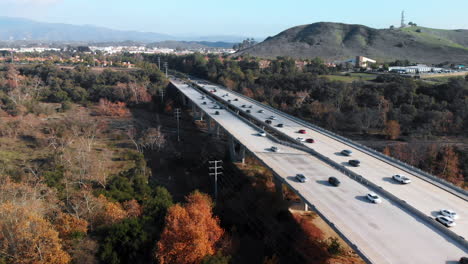 aerial rising shot over bridge traffic at higher level