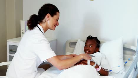 Female-doctor-consoling-sick-girl