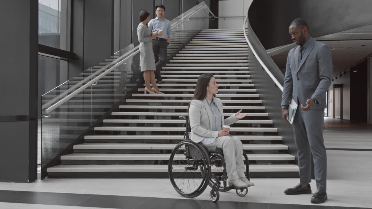 Female CEO with Disability Having Talk with Male African Employee