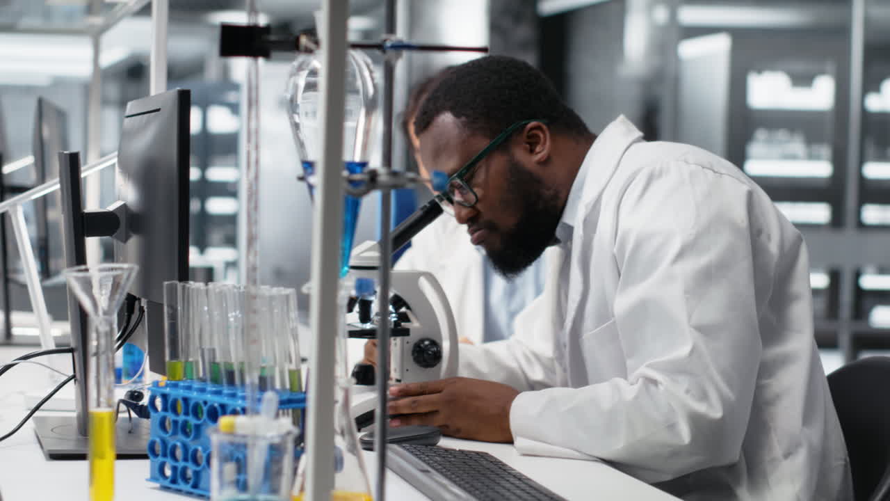 Vertical video Multiethnic nanotechnology researchers using microscope