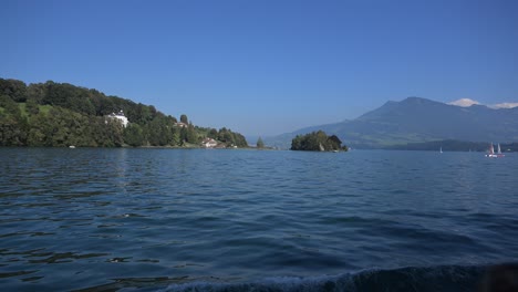 lake lucerne, switzerland - pristine blue waters of the lake and scenic beauty with sailboats, mountains and chalets