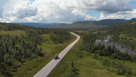 endless road through forest and mountains in national road 9, setesdal, telemark norway during summer