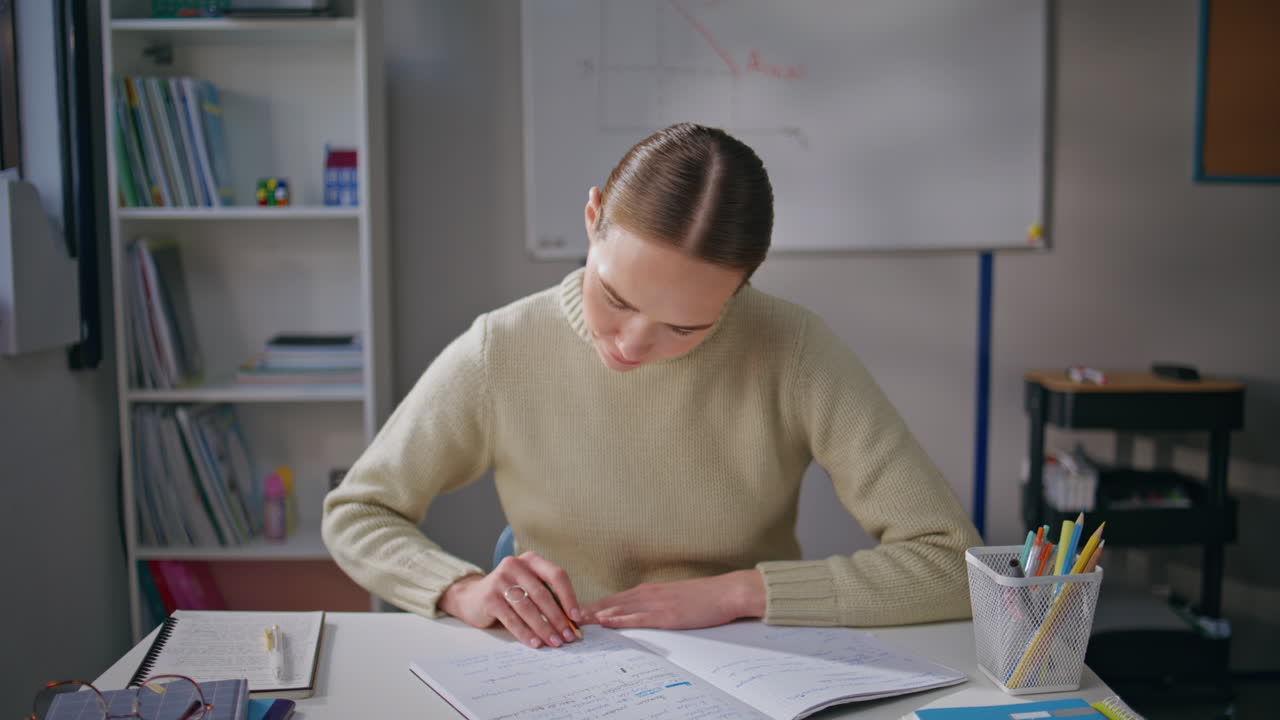 Happy tutor looking window at workplace closeup. Woman teacher checking homework