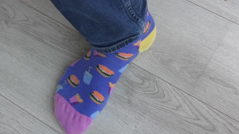 man with printed socks wearing brown leathered shoes