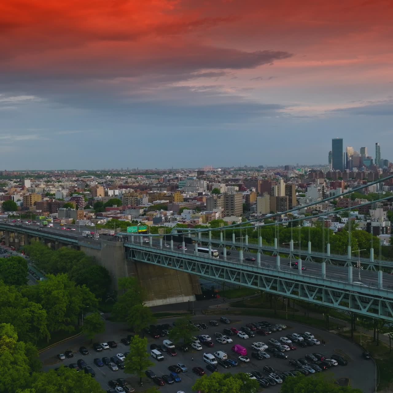 Cielo rosso mozzafiato sulla grande metropoli. Traffico intenso sul ponte Triborough a New York. La sera scende sulla città.
