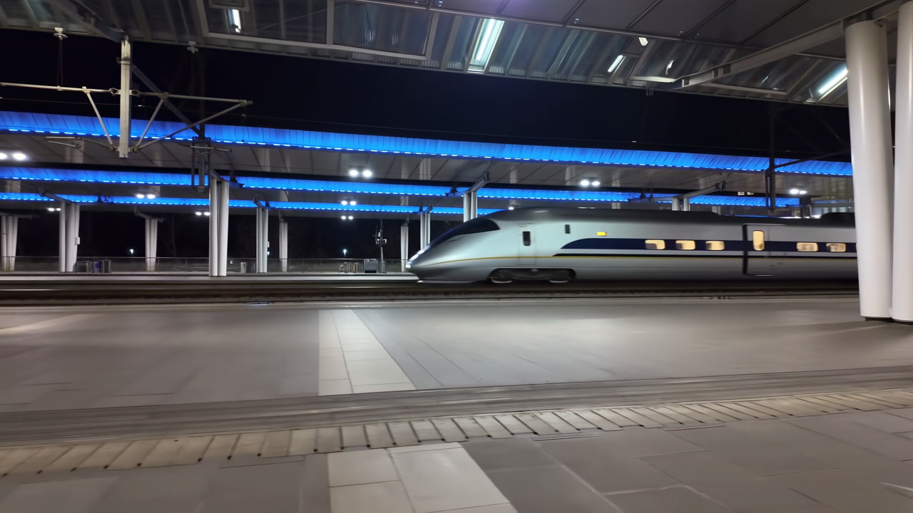Night Station High Speed Train Gliding Past Platform Under Blue Canopy, Long Exposure Motion Blur Captures