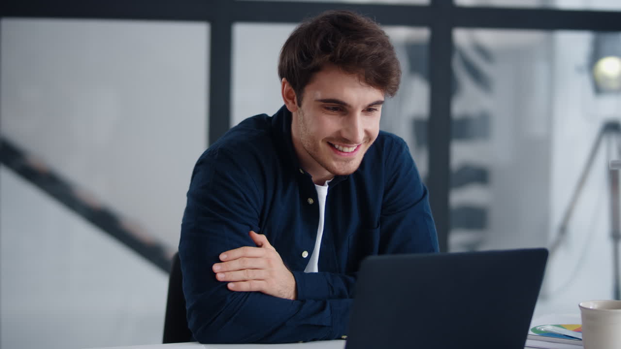Smiling businessman getting good news on email