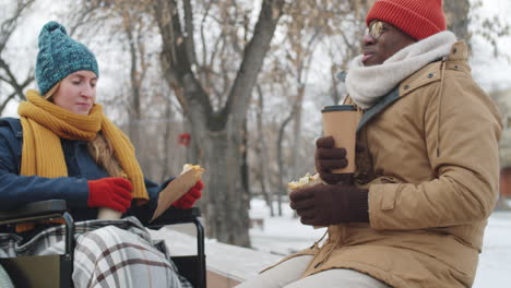 couple enjoying a winter lunch in the park