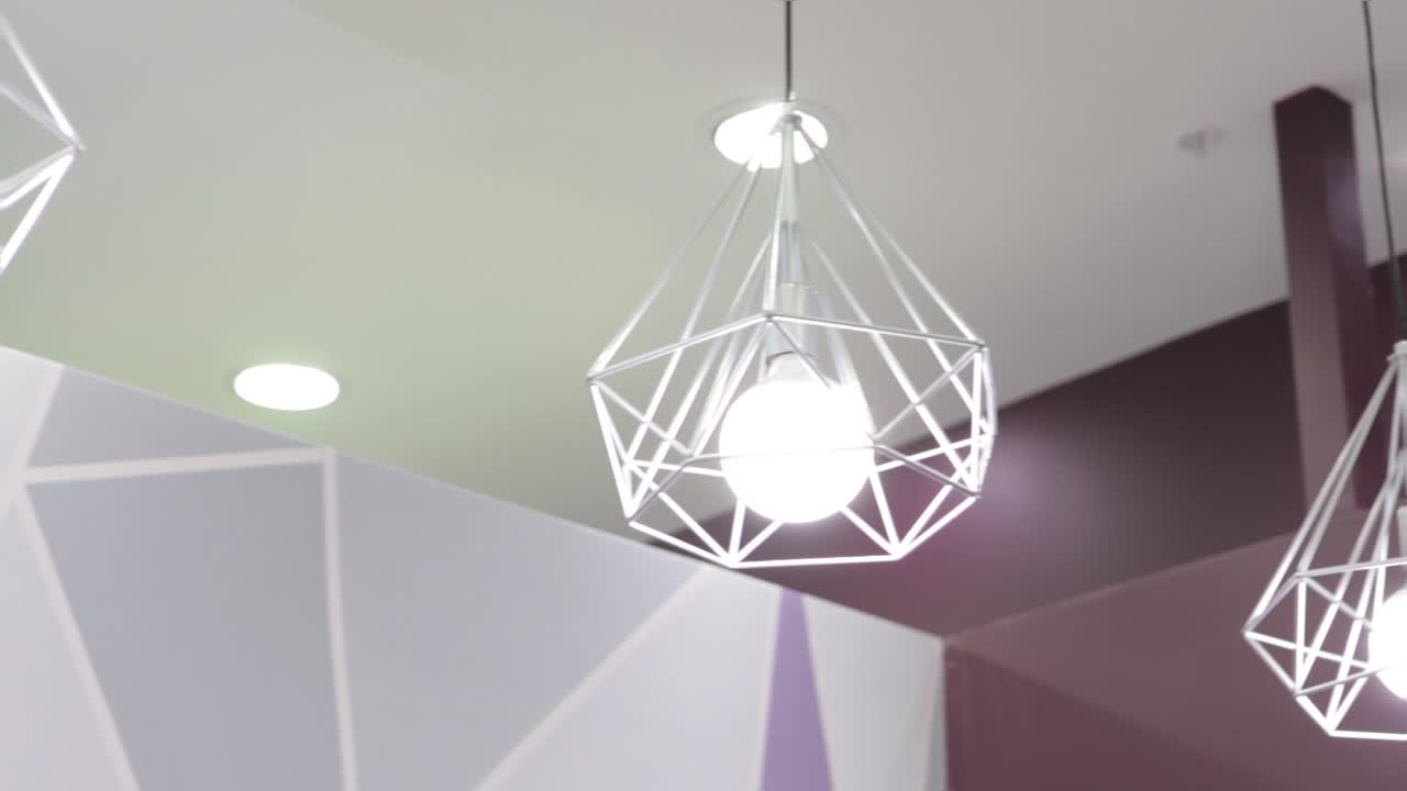 interior moderno con arte geométrico de la pared y luces colgantes