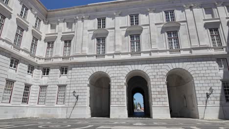 neoclassical facade of the palace of ajuda, former royal residence in lisbon, portugal, featuring numerous windows and a central red door