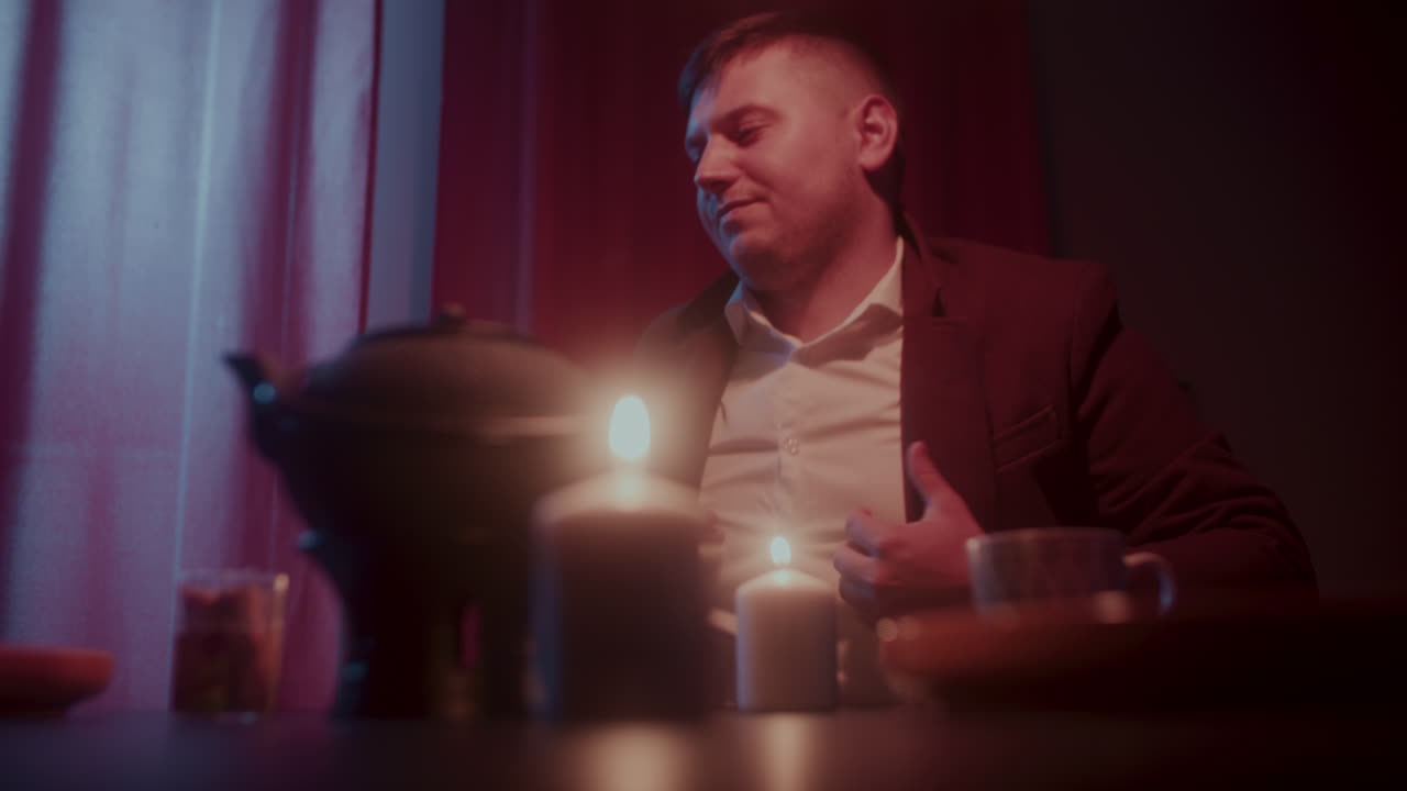 Man Enjoying a Quiet Evening Tea Ceremony