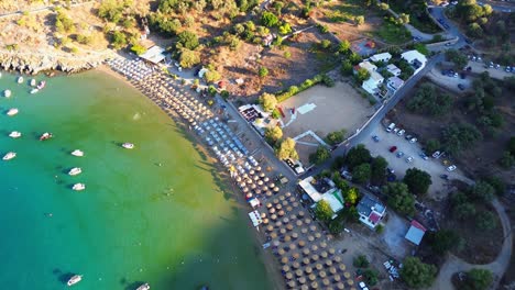 Agios-Pavlos-beach-in-Rhodes,-Greece-with-Acropolis-of-Lindos,-houses-and-Mediterranean-sea-during-the-day-filmed-with-the-drone