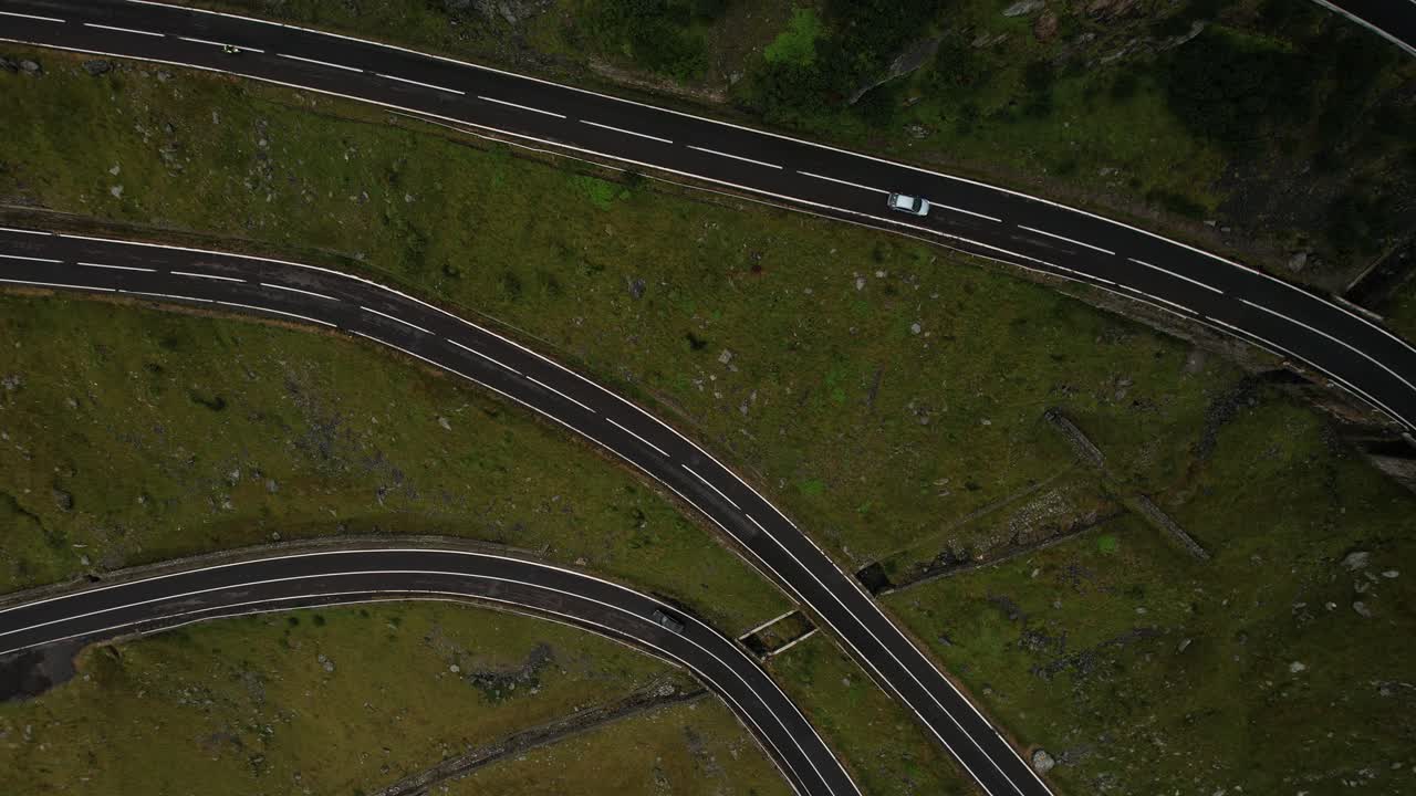 Aerial shot ascending from Transfagarasan road in Romania, circling upward into thick white clouds. Cinematic and moody 4K drone footage of nature and elevation.