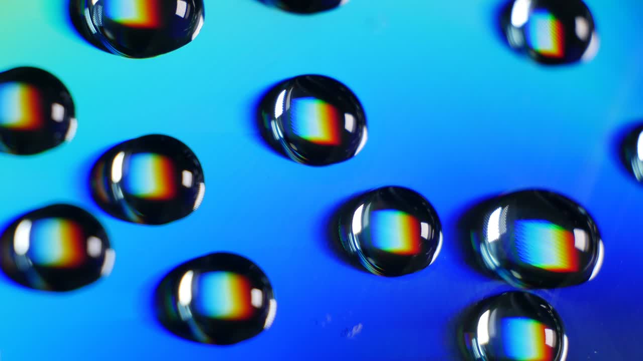 Wonderful world of physics. Interference and diffraction. Water drops close up with rainbow effect. White light is divided into components