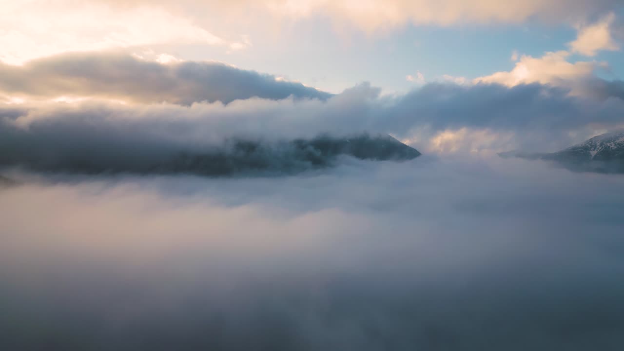 Misty Mountain Peaks Emerging Through Clouds