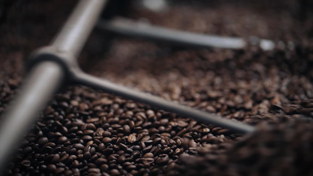 Coffee Roasting Process - Coffee beans in roasting machine. Close up in slow motion.